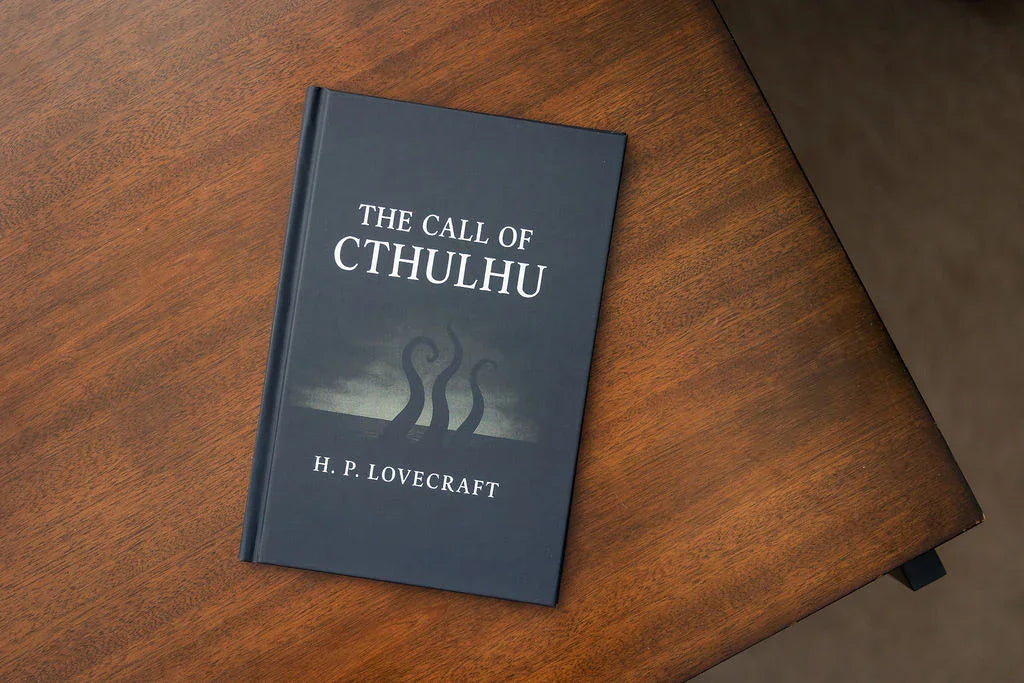 Book titled 'The Call of Cthulhu' by H. P. Lovecraft on a wooden surface