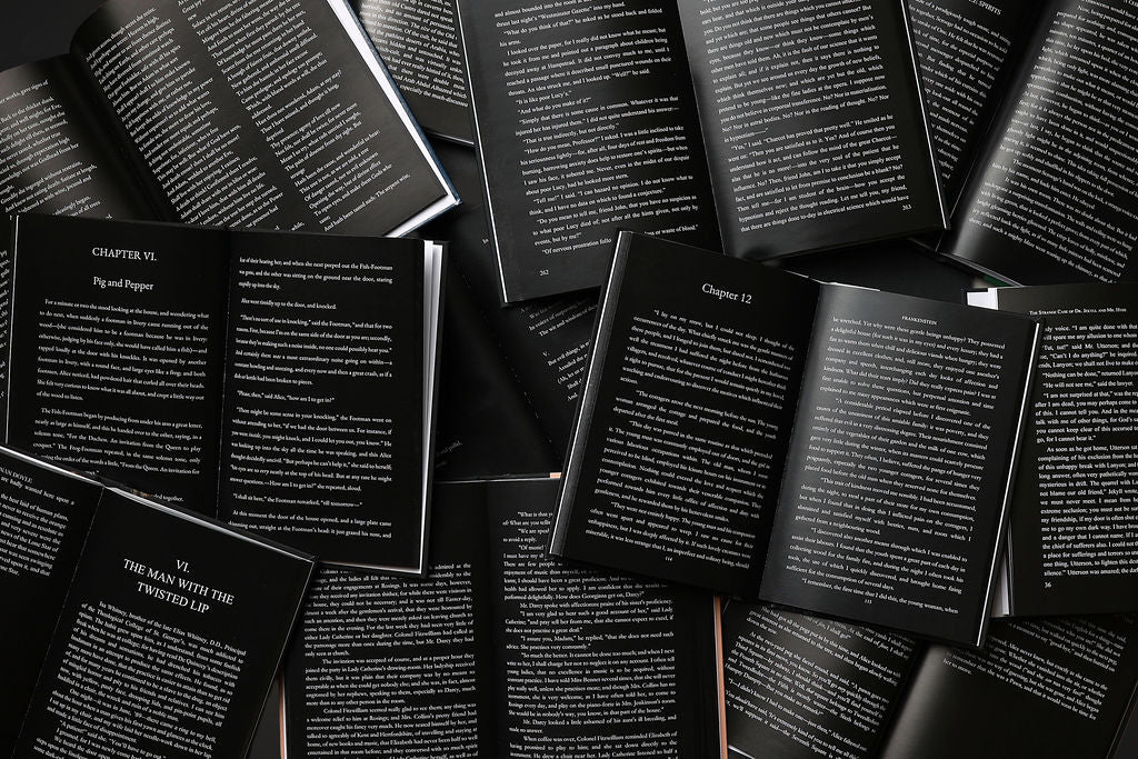 Books with black pages and white text on top of each other