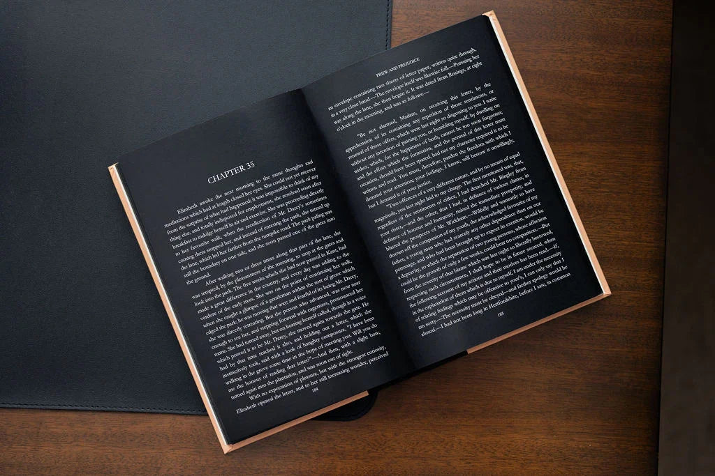 Open book on a wooden surface with text visible