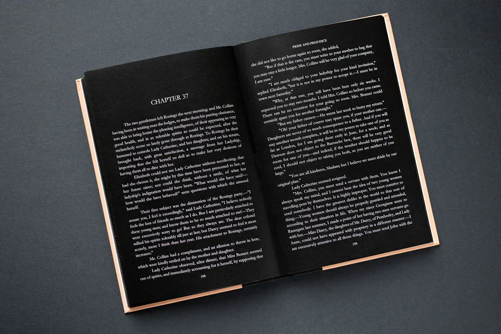 Open book with white text on a dark gray background