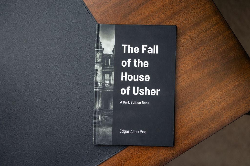 Book titled 'The Fall of the House of Usher' by Edgar Allan Poe on a wooden surface.