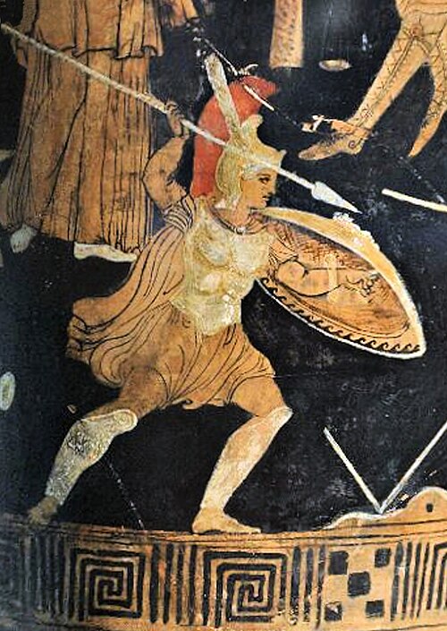 Ancient Greek warrior on a vase with detailed armor and helmet.