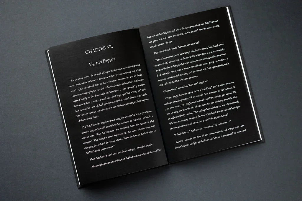 Open book with white text on a dark gray background