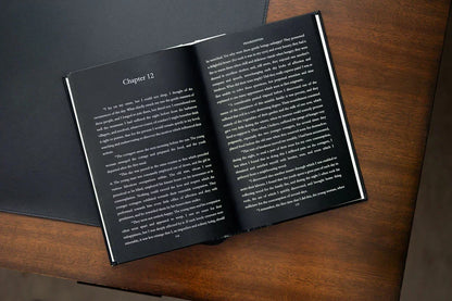 Open book on a wooden surface with text visible