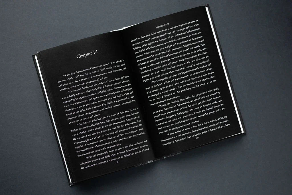 Open book with white text on a dark gray background