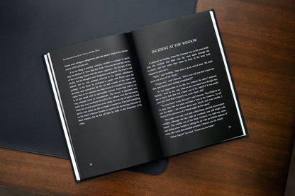 Open book on a wooden surface with text visible