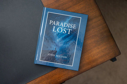 Book titled 'Paradise Lost' by John Milton on a wooden surface