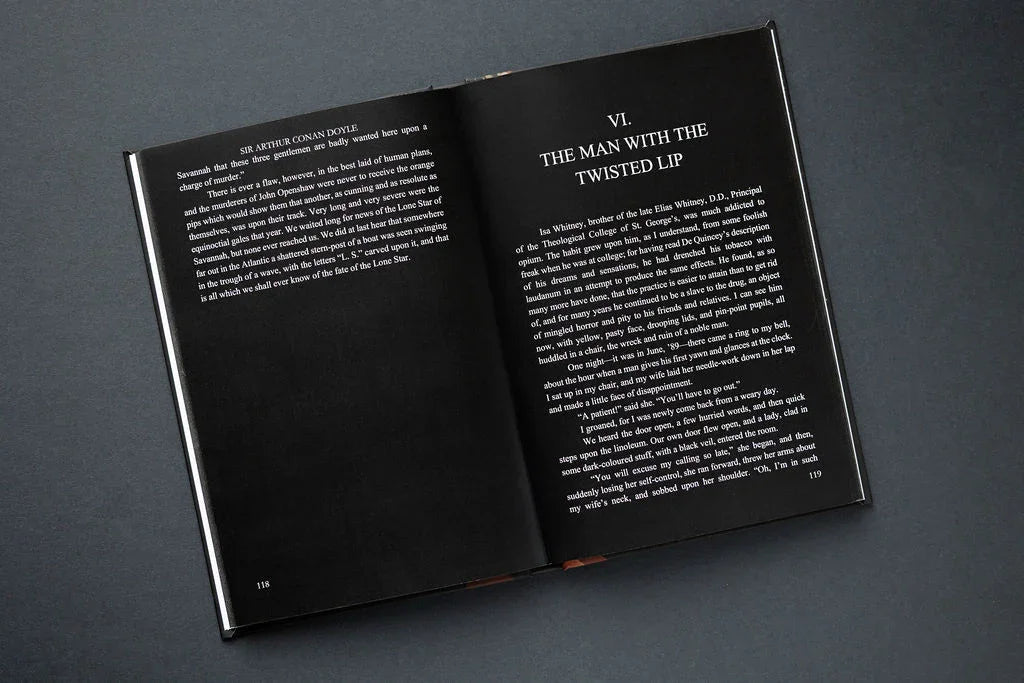 Open book with black pages and white text on a dark gray background
