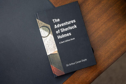 Book titled 'The Adventures of Sherlock Holmes' on a wooden surface