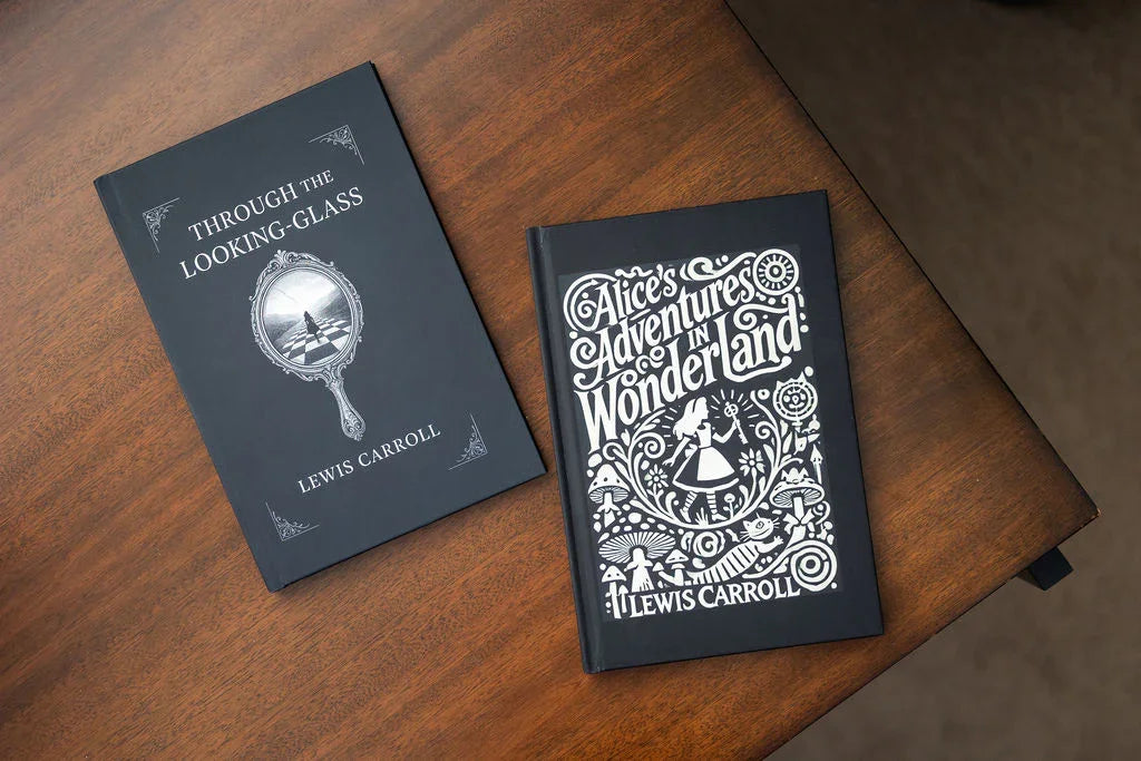Two books titled 'Through the Looking-Glass' and 'Alice's Adventures in Wonderland' by Lewis Carroll on a wooden surface.