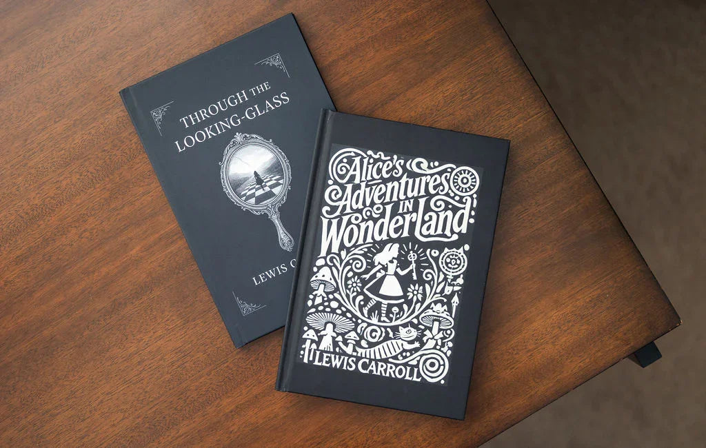Two books titled 'Through the Looking-Glass' and 'Alice's Adventures in Wonderland' on a wooden surface.